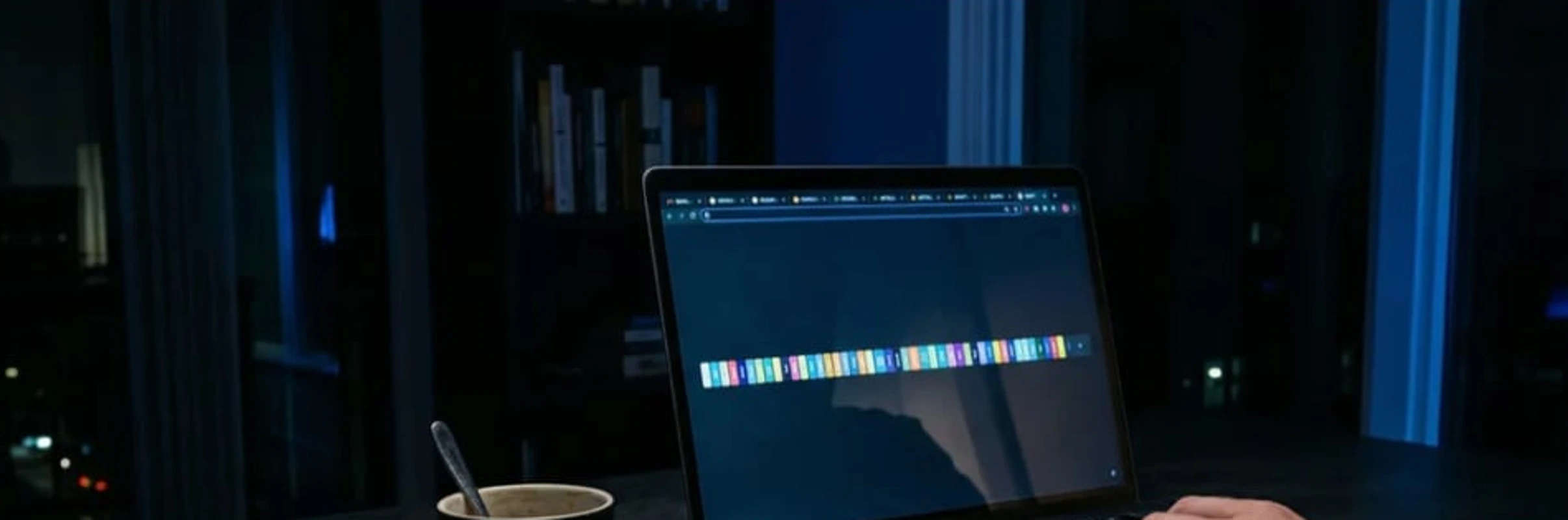 A dark editorial scene of a creator's laptop showing one strip of colorful thumbnail options competing for attention in a night editing suite